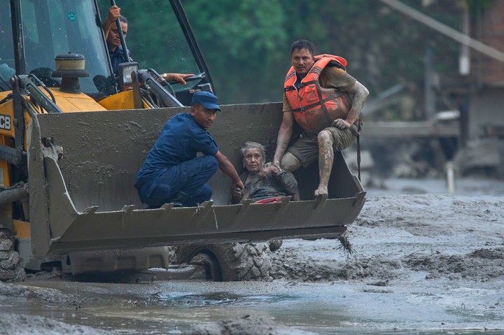 Los equipos de rescate utilizan una máquina retroexcavadora para poner a salvo a una víctima de una crecida repentina a orillas del río Trishuli, en el distrito de Nuwakot, en Nepal. AP